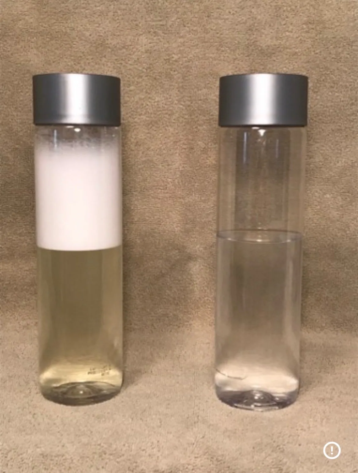 Two clear bottles side by side after shaking: the left one has a thick layer of white foam over yellow liquid, the right one is clear with no foam